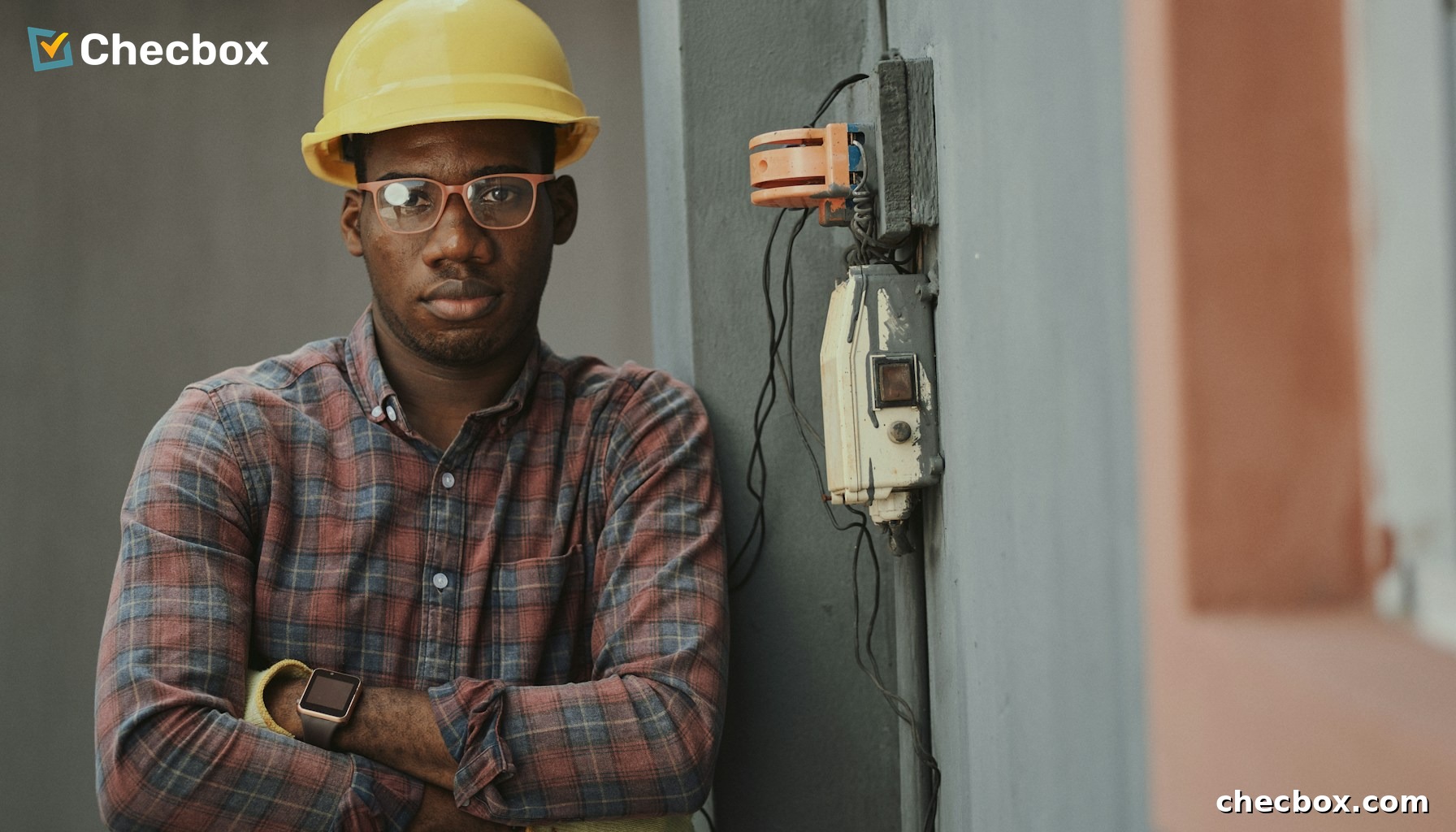 Electrician working on electrical wiring with mobile app